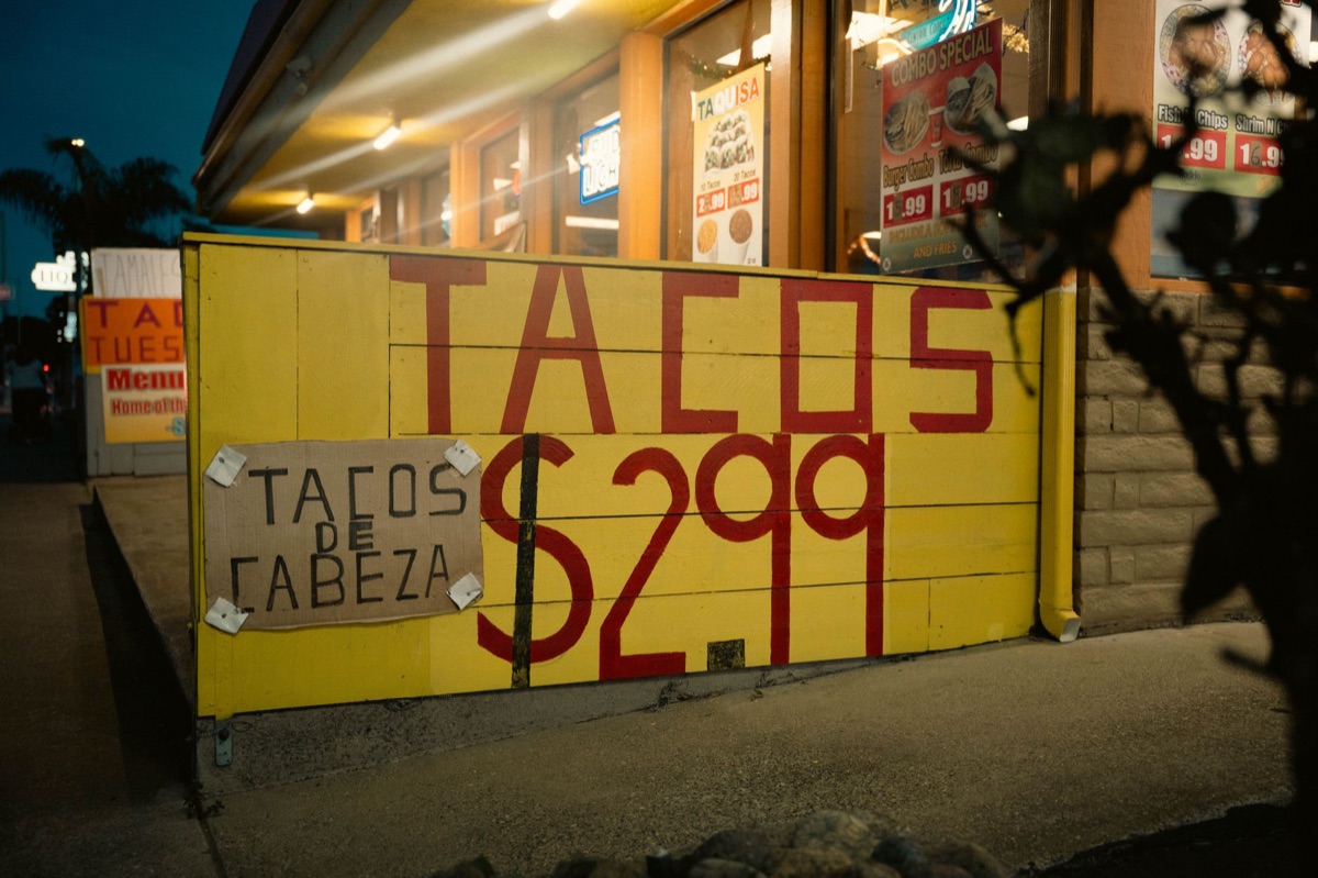 Cancun taco stand with colorful signs and food