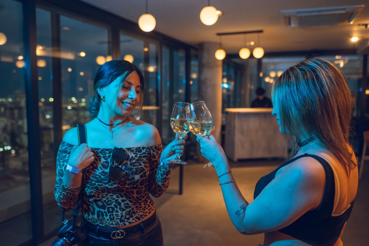 Cancun rooftop bar at night with guests and skyline view