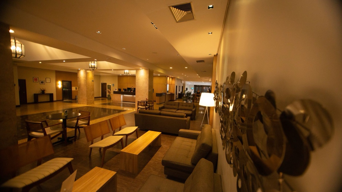 John Hotel Cancun lobby with a grand staircase and reception desk.