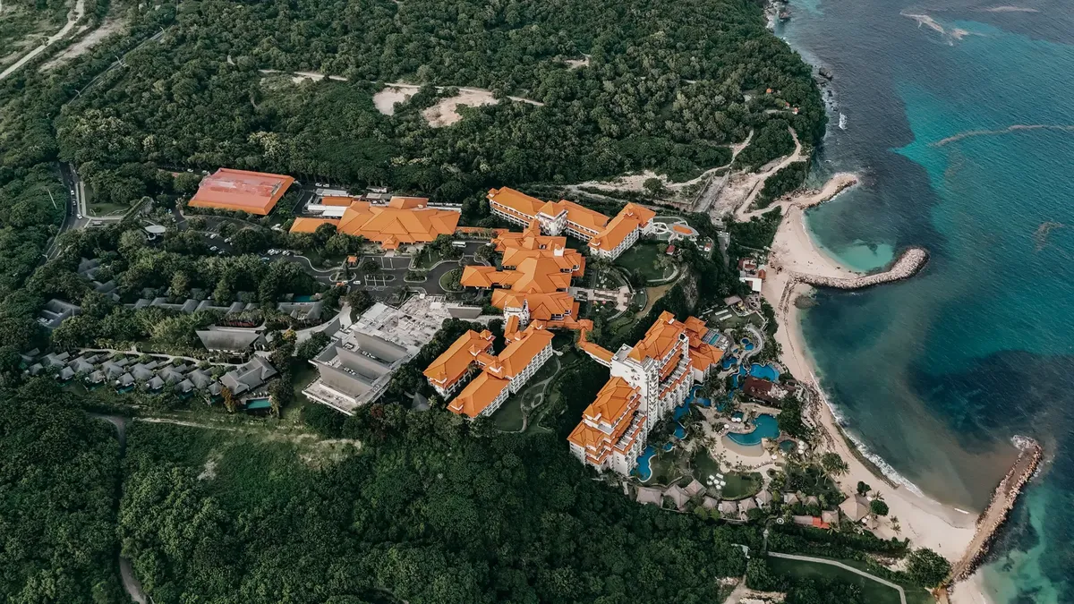 Stunning aerial view of a luxury resort in Bali, Indonesia with vibrant surroundings.